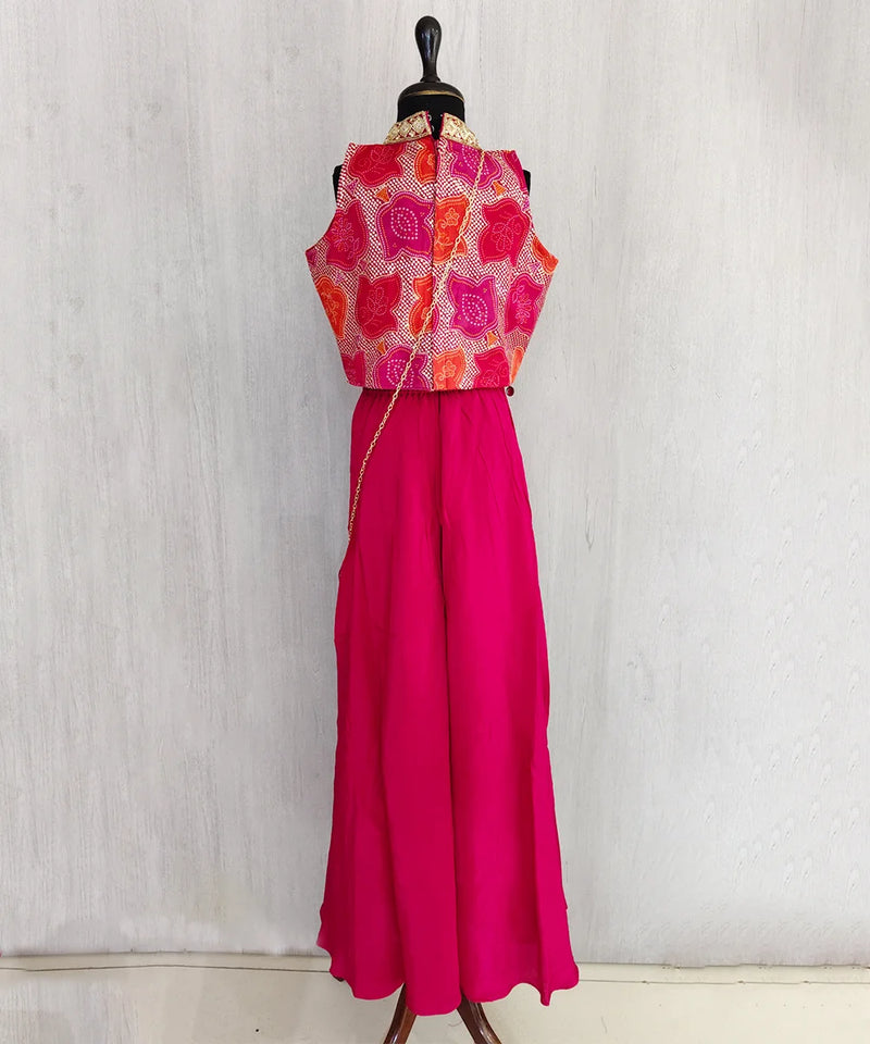 Mannequin wearing a red and pink traditional outfit with a white background