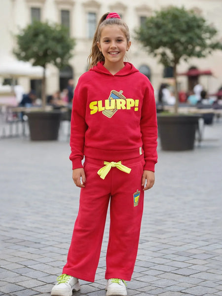 Child wearing a red 'SLURP!' hoodie and pants in an outdoor setting