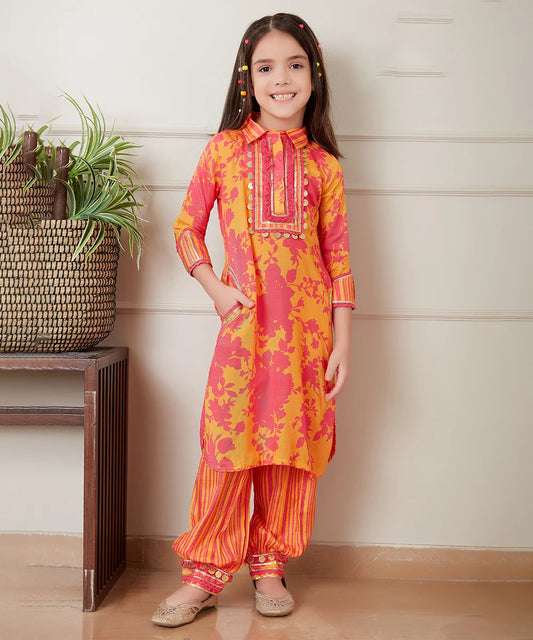  It Consists of a self-printed yellow and orange coloured kurta and self-striped pants for a little girl. A Great option as a kid’s festive wear. This dress has a pocket and beautiful coin detailing that uplifts the entire look. 