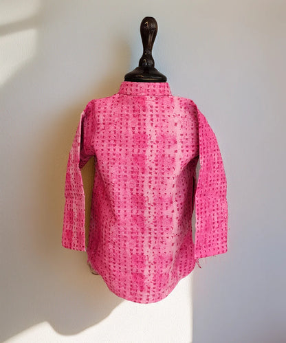Pink textured shirt on a mannequin against a white background