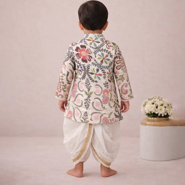 Child wearing a traditional outfit with floral patterns on a plain background