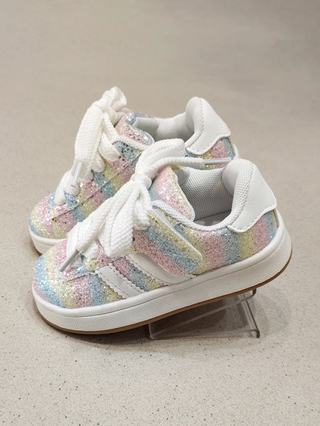 Pair of colorful sneakers with white laces on a neutral background