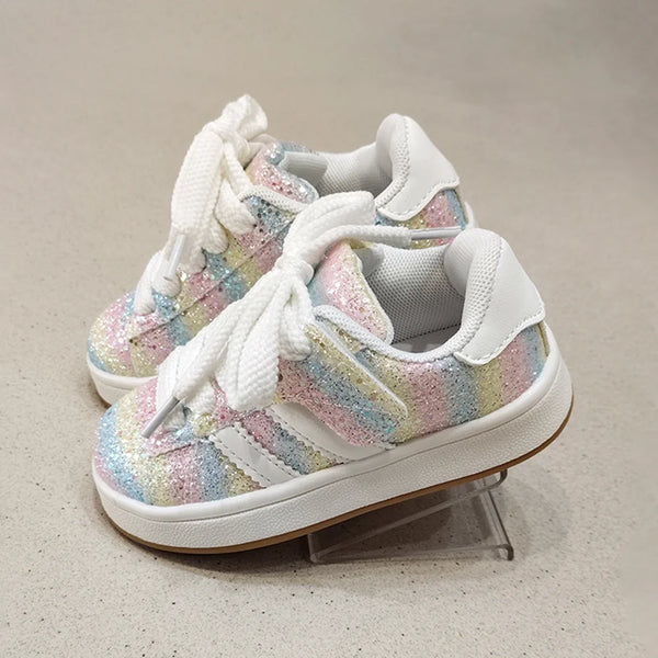 Pair of colorful sneakers with white laces on a neutral background