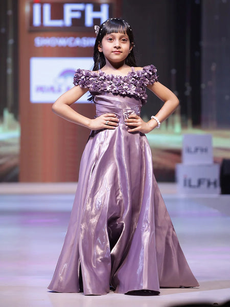  It’s a beautiful purple coloured party-wear baby girl gown with a back zip closure paired up with a matching inner. It features floral work with classic pleated detailing on the yoke and a fabric belt to be tied at the back. 