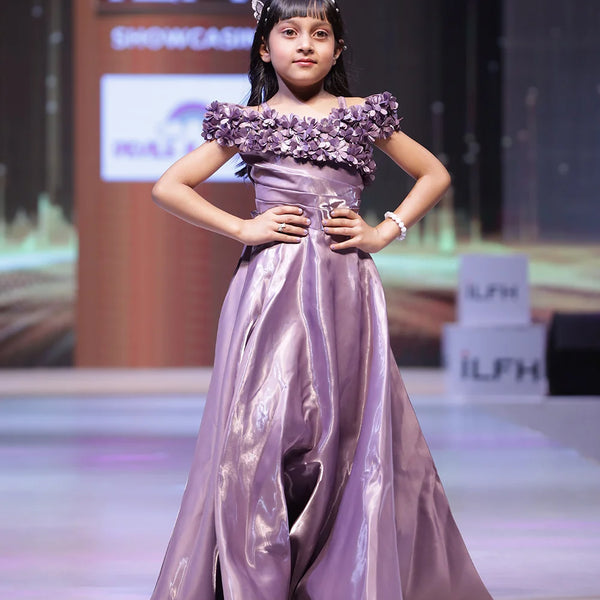  It’s a beautiful purple coloured party-wear baby girl gown with a back zip closure paired up with a matching inner. It features floral work with classic pleated detailing on the yoke and a fabric belt to be tied at the back. 