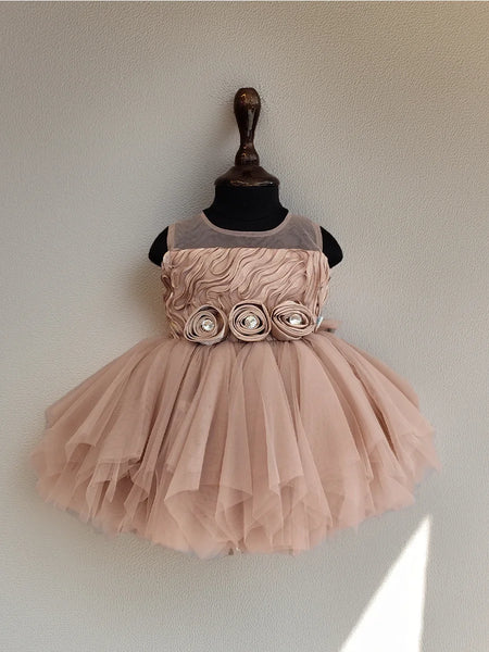 Pink dress with floral details on a mannequin against a plain background