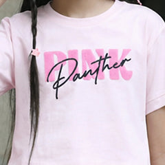 A close-up of a child wearing a light pink short-sleeve T-shirt with a large graphic print reading 'PINK Panther' across the chest. The 'PINK' text is in a bold pink block font, overlaid with 'Panther' in black cursive script.