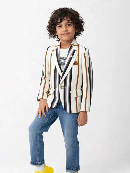 Child wearing a striped blazer and jeans on a white background