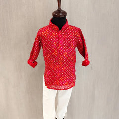 Red patterned shirt on a mannequin against a neutral background