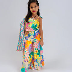Young girl wearing a colorful floral outfit on a plain background