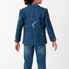 Child wearing a blue jacket with geometric patterns on a white background