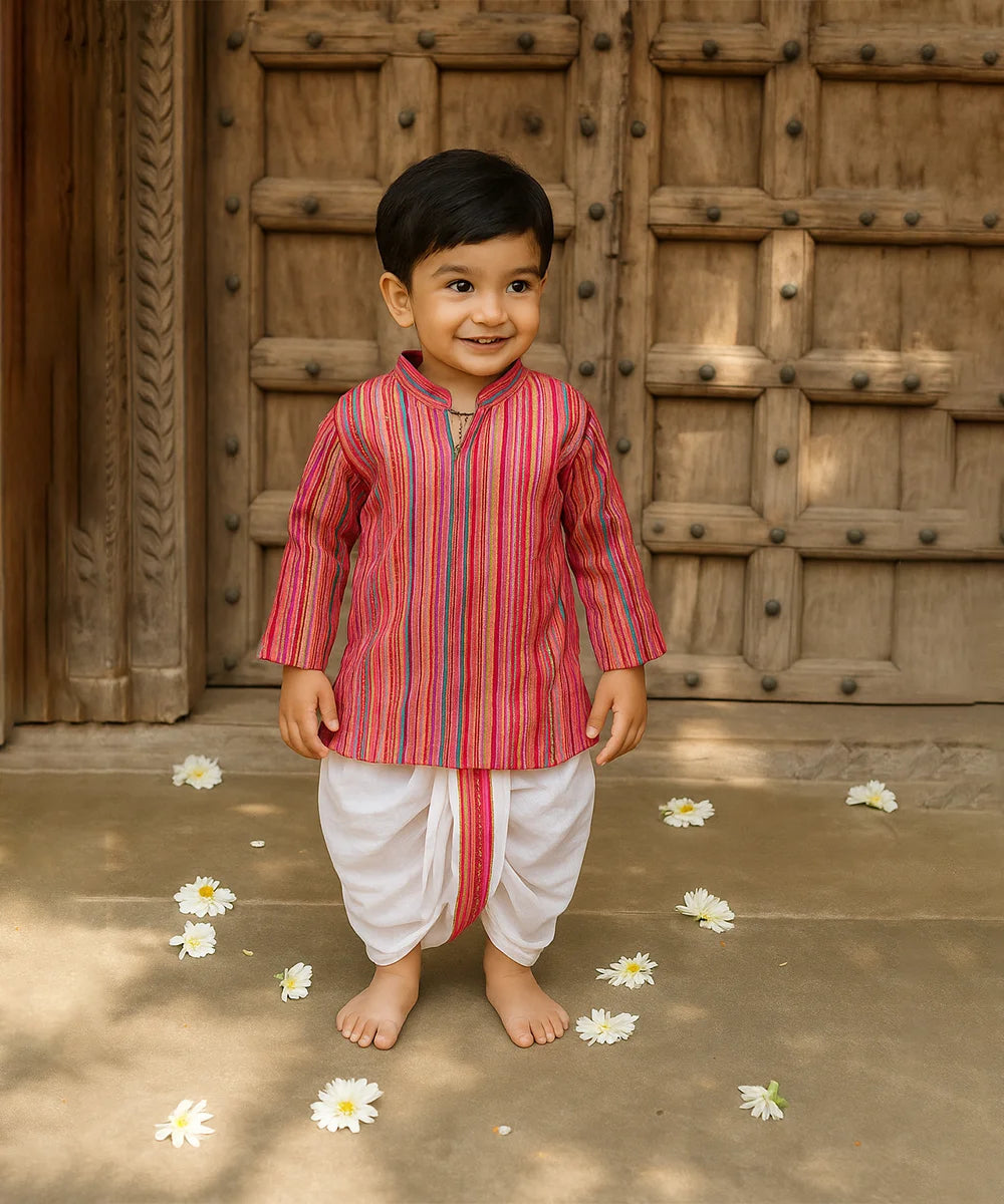 Child wearing a traditional outfit with a wooden door in the background