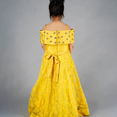 Yellow off-shoulder dress with floral details on a gray background