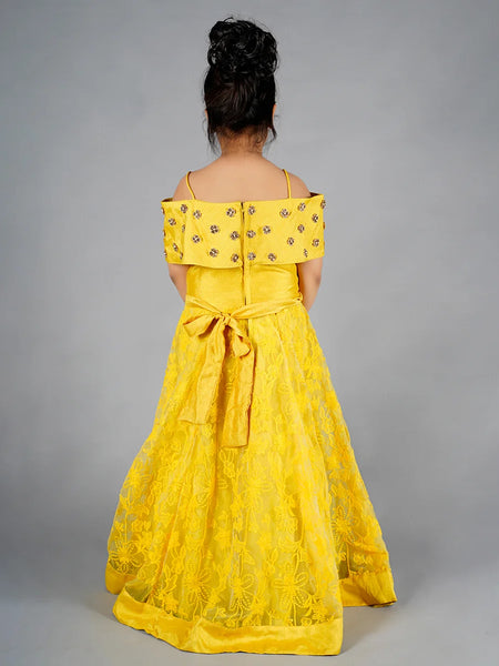 Yellow off-shoulder dress with floral details on a gray background