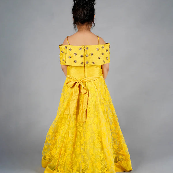 Yellow off-shoulder dress with floral details on a gray background