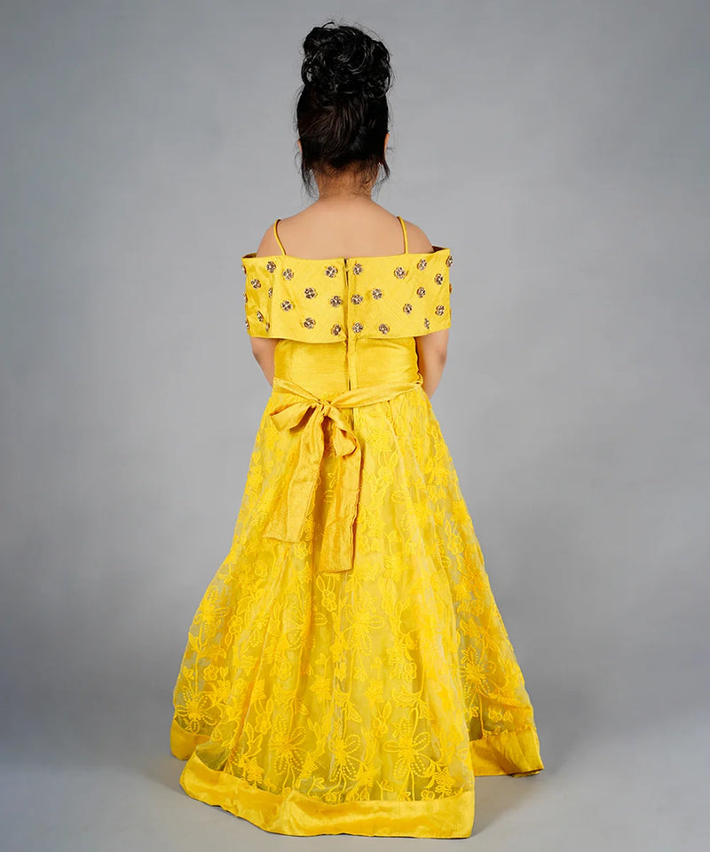 Yellow off-shoulder dress with floral details on a gray background