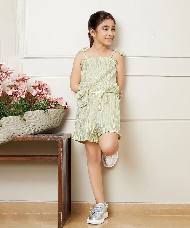 It is a beautiful Pista green Colored jumpsuit with an elasticated waist and shimmer dots all over the dress with a cute neck detailing. It comes with a matching belt and a mini purse.