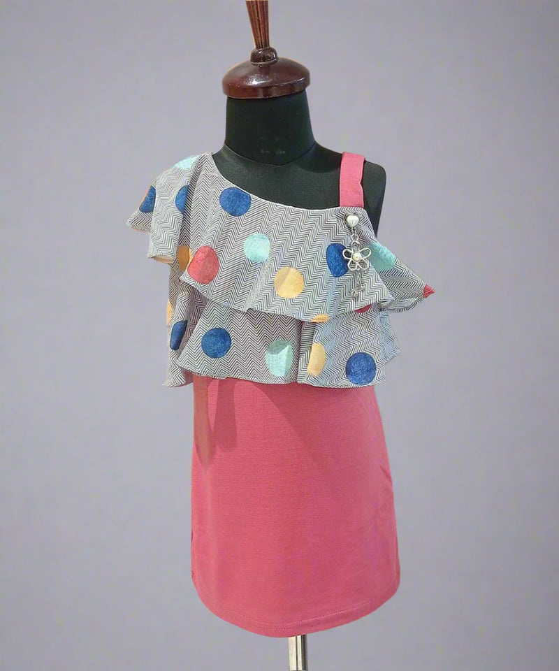 It’s a straight fit pink and grey Colored trendy dresses for kids that comes with a polka-dotted ruffled neck for party looks.  It features a beautiful broach and a back zip closure.
