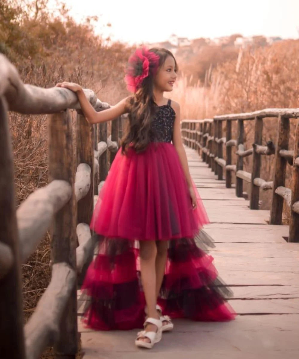It’s a fancy pink and black Colored up-and-down gown that comes with a trail and is a perfect children birthday dress. It features a matching hairpin that uplifts the entire look. 