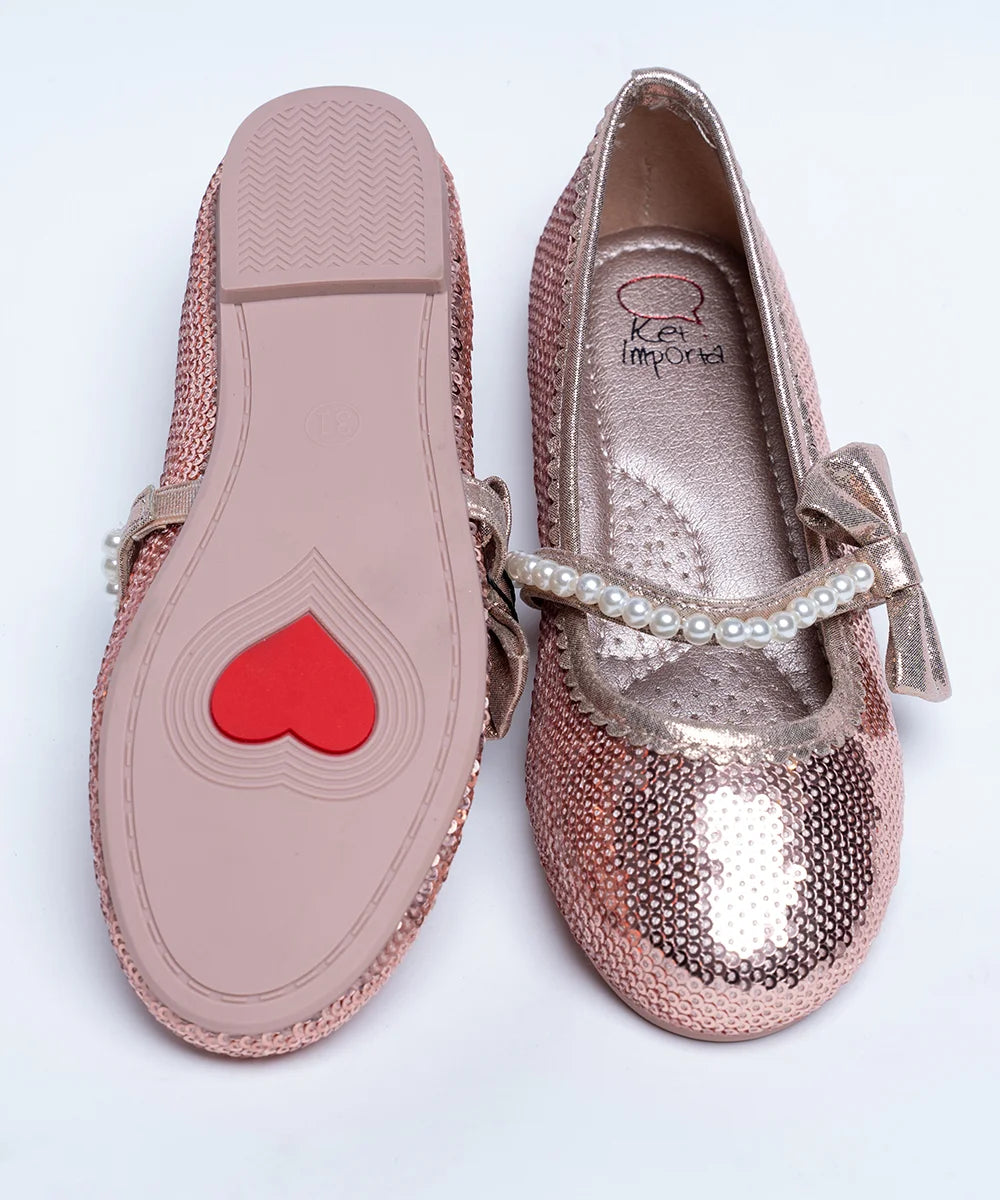 It's a pair of rose-gold Colored party-wear sandals for wedding parties. It features Patterned synthetic outsole, pearl and bow detailing on the belt.