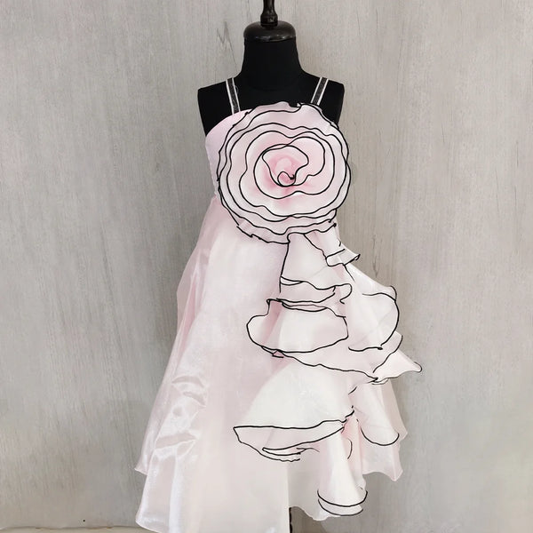 Mannequin wearing a white dress with floral design on a plain background