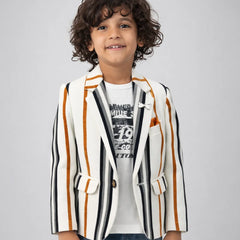 Child wearing a striped blazer over a graphic t-shirt on a plain background