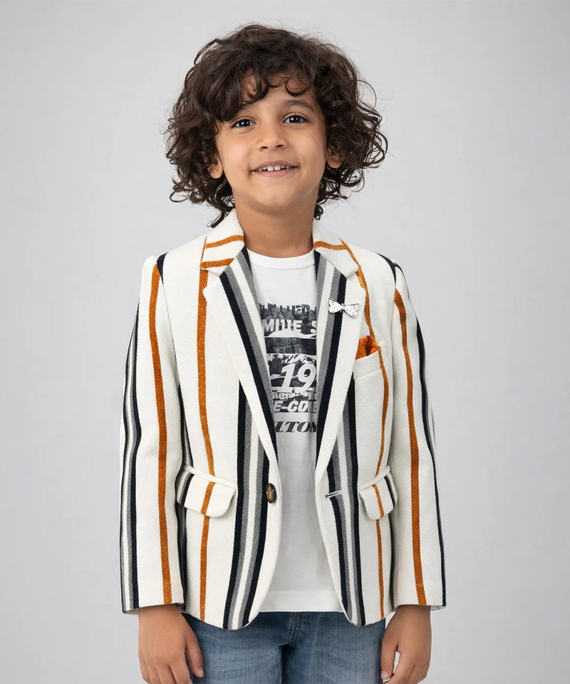 Child wearing a striped blazer over a graphic t-shirt on a plain background