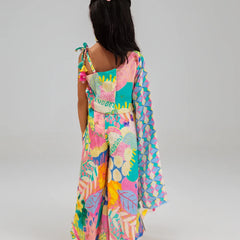 Girl wearing a colorful patterned dress on a plain background