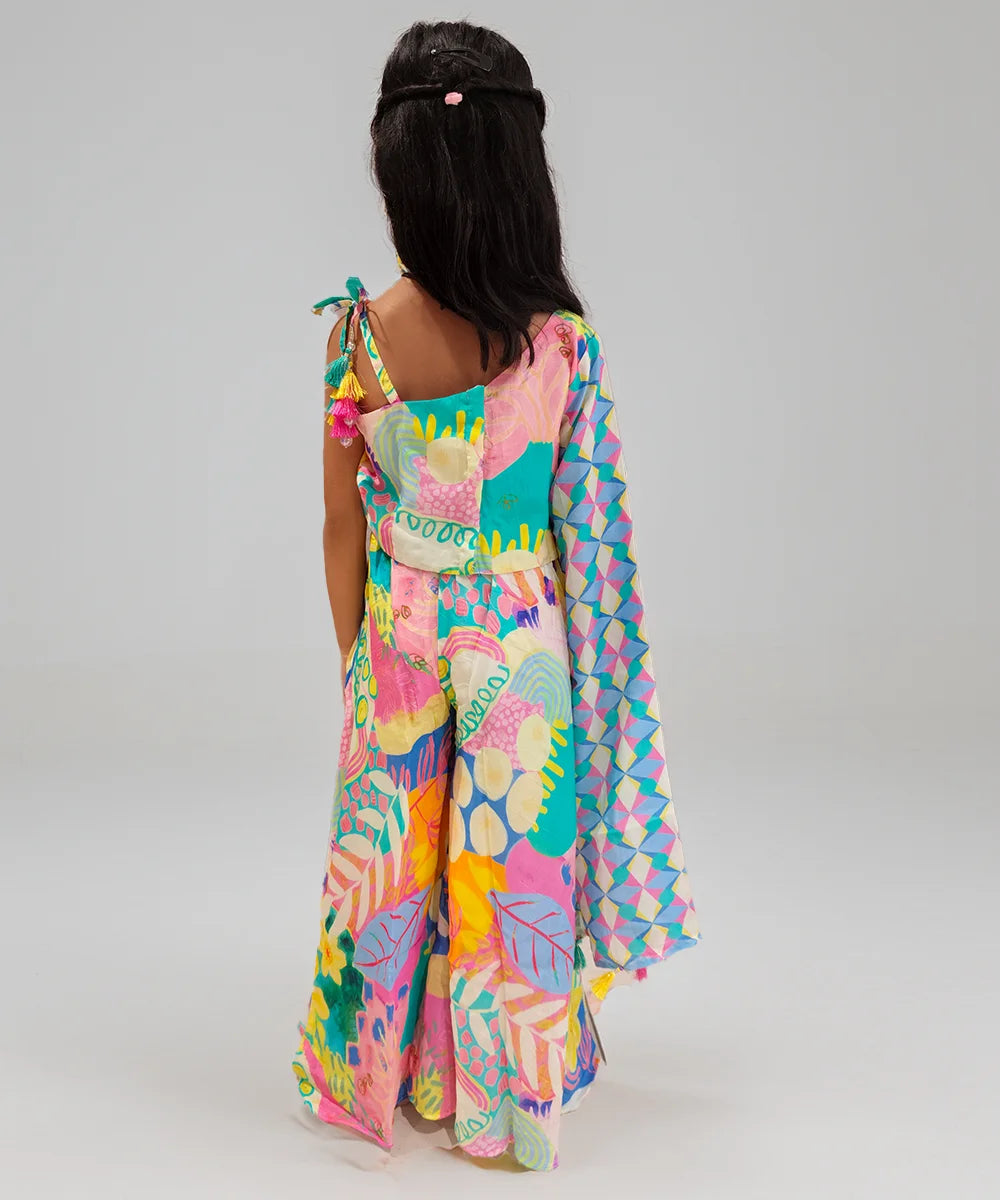 Girl wearing a colorful patterned dress on a plain background