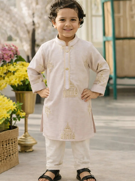 Child wearing a traditional outfit with floral decorations in the background