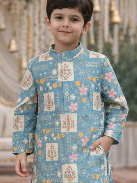 Child wearing a blue traditional outfit with floral and geometric patterns.