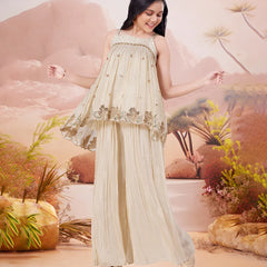 Girl in a beige dress with floral patterns against a desert landscape background