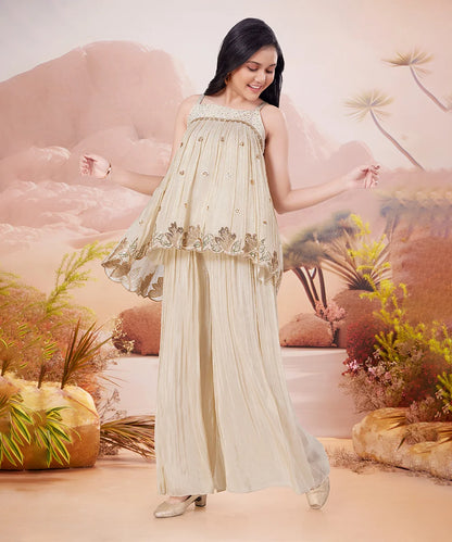 Girl in a beige dress with floral patterns against a desert landscape background