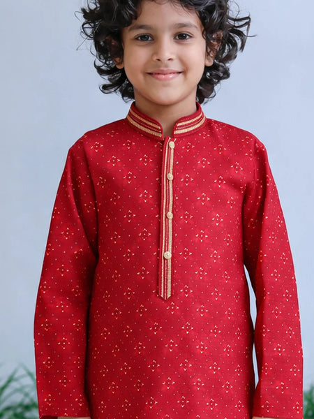 Child wearing a red traditional outfit with gold accents against a light blue background