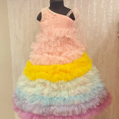 It’s a beautiful ruffle gown, a perfect children birthday dress as well as girls wedding outfit. It features a beautiful pearl detailing on the shoulder that uplifts the entire look. Moreover, it comes with a matching fabric belt to be tied at the back.