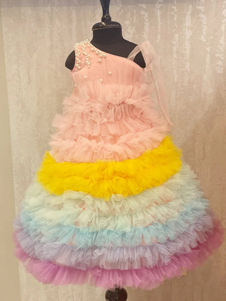 It’s a beautiful ruffle gown, a perfect children birthday dress as well as girls wedding outfit. It features a beautiful pearl detailing on the shoulder that uplifts the entire look. Moreover, it comes with a matching fabric belt to be tied at the back.