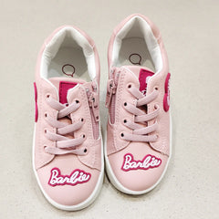 Pink sneakers with 'Barbie' logo on a light background