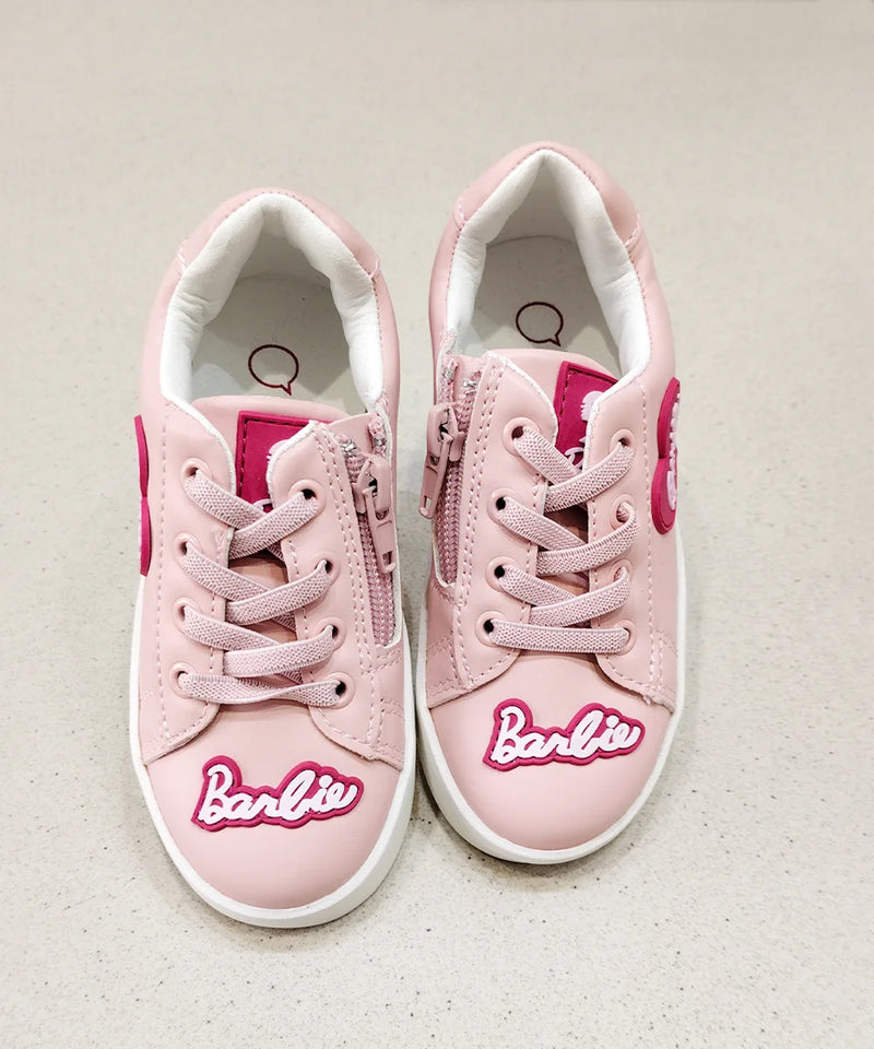 Pink sneakers with 'Barbie' logo on a light background