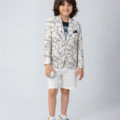 Child wearing a patterned blazer and white shorts on a plain background