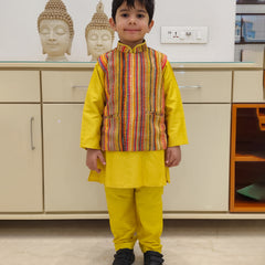 It is a yellow color plain kurta pajama with a multi striped jacket