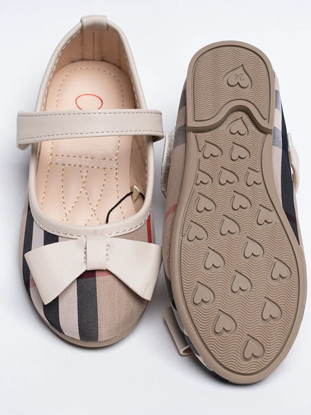 Close-up of girls' beige tartan dress flats with bow accent and quilted footbed, Jaipur