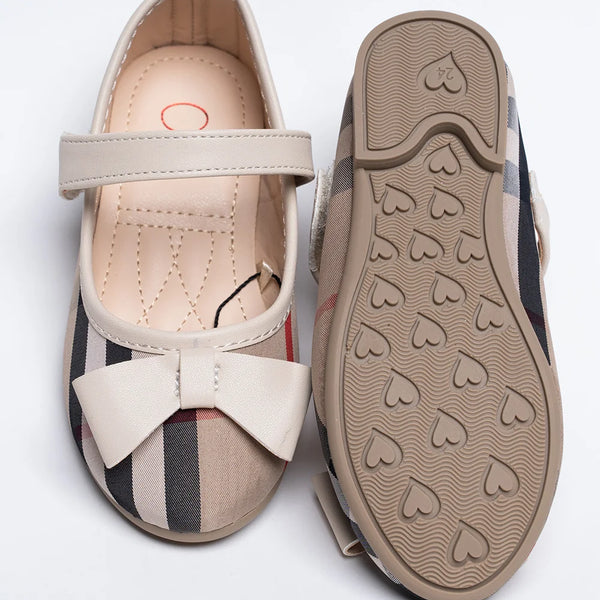 Close-up of girls' beige tartan dress flats with bow accent and quilted footbed, Jaipur