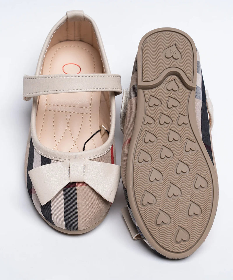 Close-up of girls' beige tartan dress flats with bow accent and quilted footbed, Jaipur
