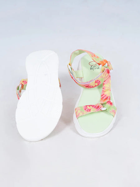 Close-up of trendy girls' summer sandals with vibrant tie-dye straps and white sole, Jaipur