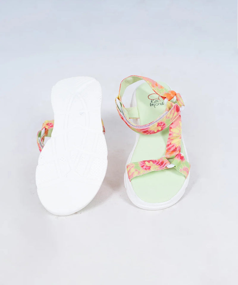 Close-up of trendy girls' summer sandals with vibrant tie-dye straps and white sole, Jaipur