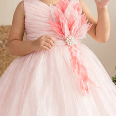 Close-up of pink 3D flower with pearl centre on baby girl frock