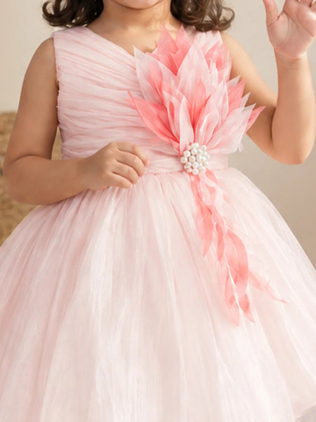 Close-up of baby girls' pink 3D flower with pearl centre