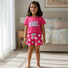 Young girl wearing pink pajamas with floral pattern in a bedroom