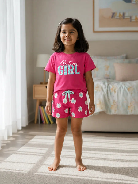 Young girl wearing pink pajamas with floral pattern in a bedroom