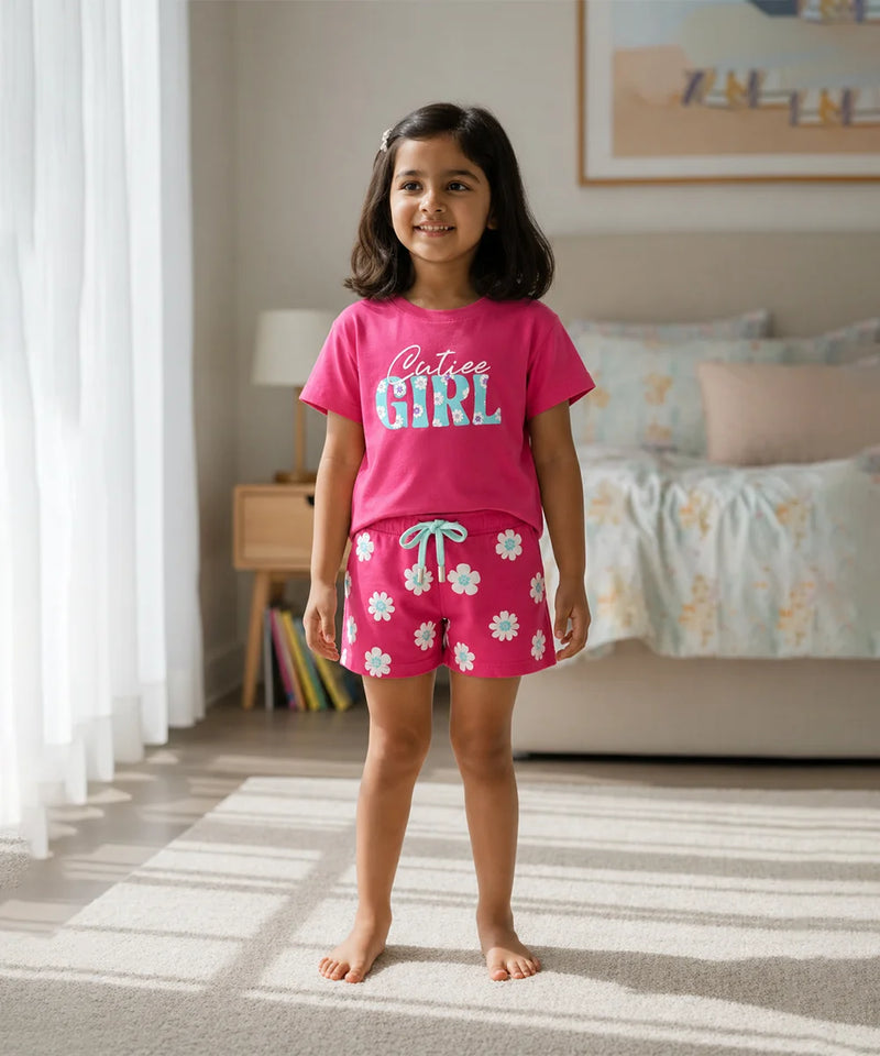 Young girl wearing pink pajamas with floral pattern in a bedroom